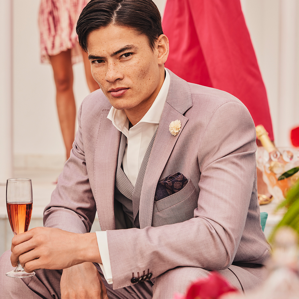 young man with brown hair in rose coloured wedding suit